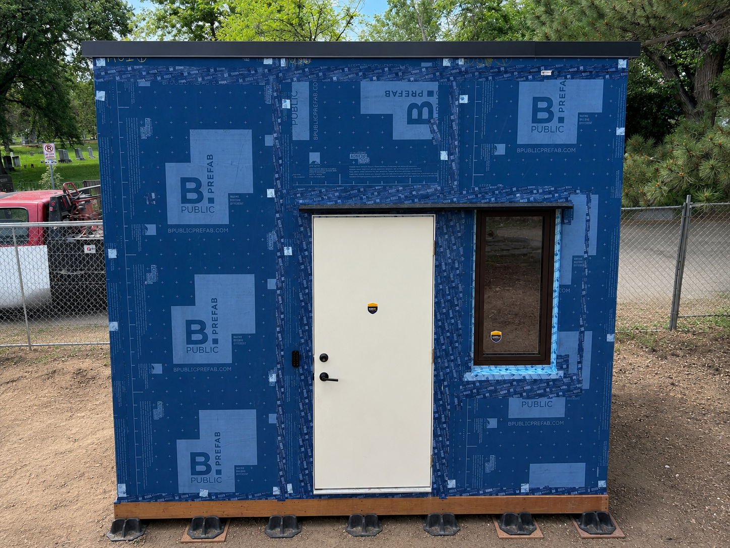Shed front face showing door and triple-glazed window